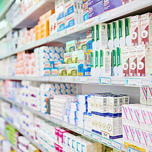 An aisle in a pharmacy. The commercial product(s) or designs displayed in this image represent simulations of a real product, and are changed or altered enough so that they are free of any copyright infringements. Our team of retouching and design specialists custom designed these elements for each photo shoot