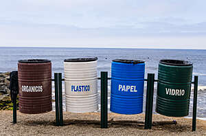 Colorful recycling bins for collecting recyclable waste on the beach front in Lima, Peru.