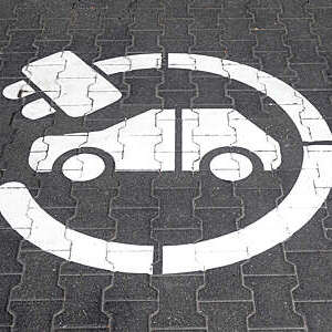 Electric charging station symbol and inscription on a street. 