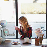 Pepper the robot and a young woman chatting